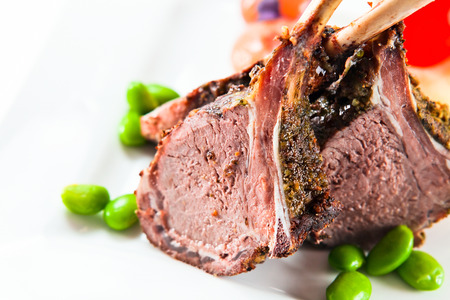 Stewed mutton with green string bean on a white plateの写真素材