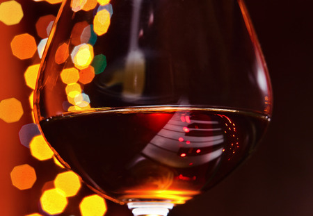 snifter with brandy on a old pianoの写真素材