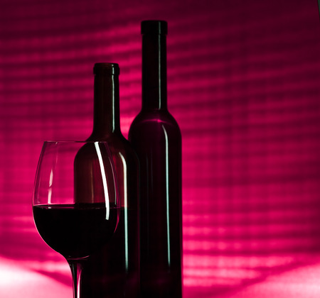 bottles and glass with pink  wine on dark backgroundの写真素材