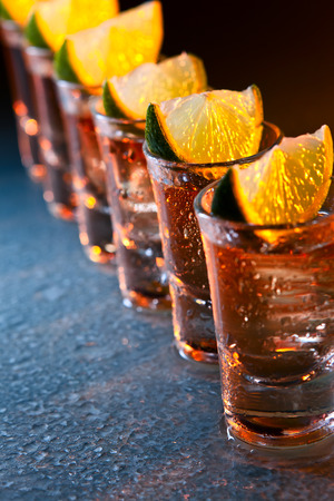 tequila and lime on wet glass tableの写真素材