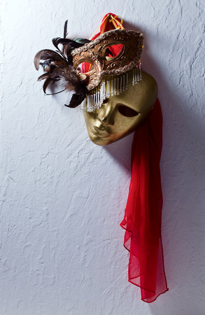 Two golden Venetian masks on  old wallの写真素材