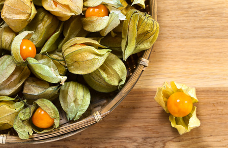 Physalis in basket on a wooden tableの写真素材