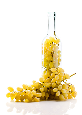 ripe grape in bottle on white background.の写真素材