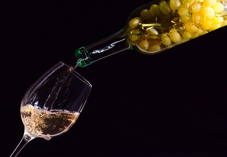 White wine being poured into a wineglass.の写真素材