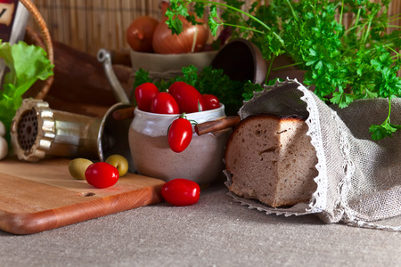 fresh vegetables and bread on a kitchen tableの写真素材
