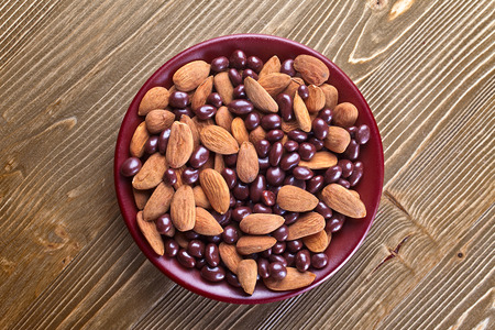black chocolate and almond nuts  on wooden tableの写真素材