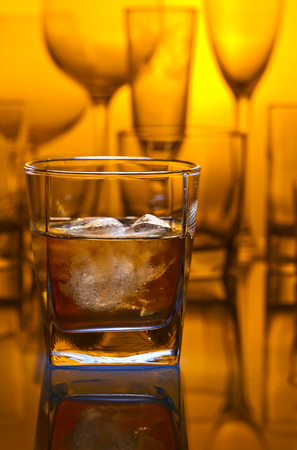 whiskey with natural ice on glass table in barの写真素材