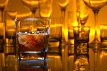 whiskey with natural ice on glass table in barの写真素材