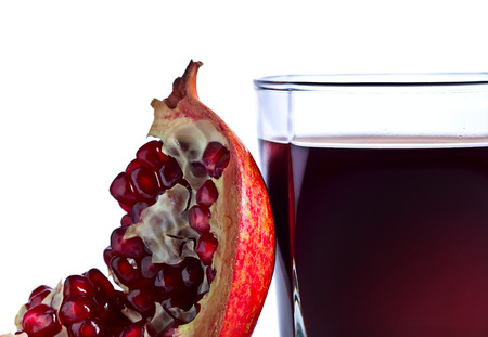 ripe pomegranate and juice isolated on a white  backgroundの写真素材