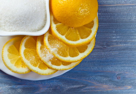Fresh lemon with sugar on  white plateの写真素材