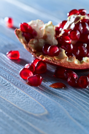 ripe pomegranate on a old wooden tableの写真素材