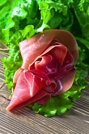 jamon with salad on old wooden tableの写真素材