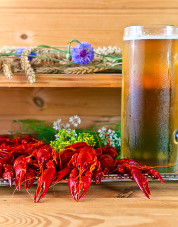 boiled crayfish with beer on wooden tableの写真素材