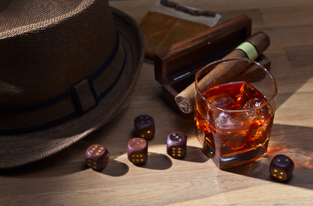 whiskey and dice on a wooden tableの写真素材