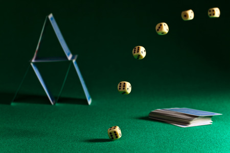 dice and playing cards on green tableの写真素材