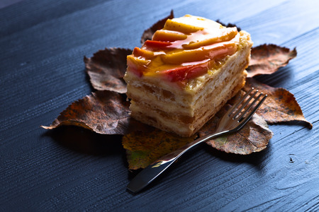 sweet pie with apples and jelly on a black wooden table