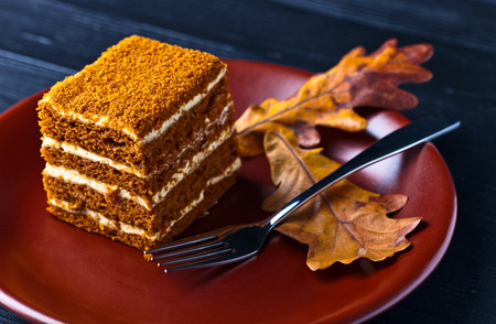 sweet homemade honey cake on a black wooden tableの写真素材
