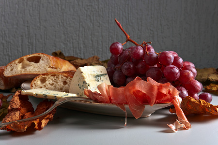 grapes , bread and snacks to red wineの写真素材