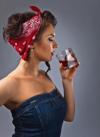 portrait of young beautiful woman with whiskey