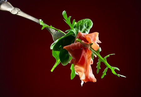 jamon with spinach and  arugula on dark backgroundの写真素材