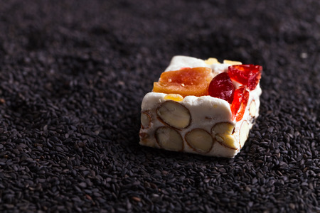 Soft nougat with tropical fruit on black sesameの写真素材