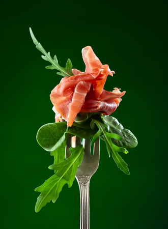 jamon with spinach and  arugula on dark backgroundの写真素材