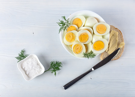breakfast with boiled eggs on white tableの写真素材