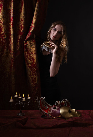 Portrait of young beautiful blonde with a gold Venetian maskの写真素材