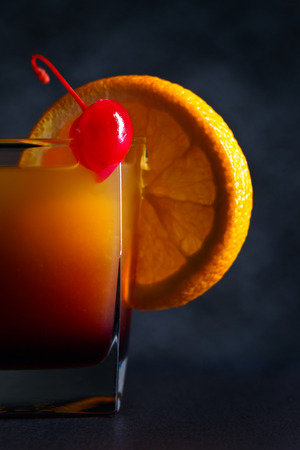 cocktail Tequila sunrise and orange on a dark backgroundの写真素材