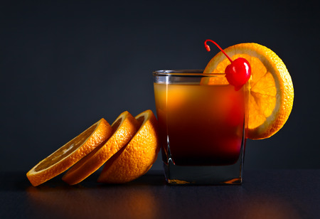 cocktail Tequila sunrise and orange on a dark backgroundの写真素材