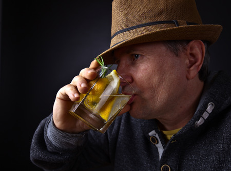 Portrait of a man with a glass of lemon drink