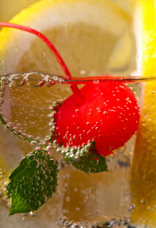 cold drink with lemon  and sweet cherryの写真素材