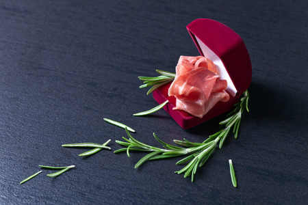 jamon with rosemary on a dark background