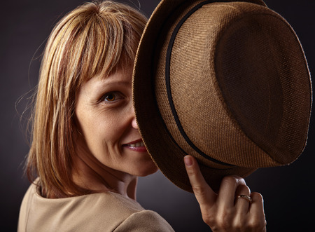 portrait of happy red-haired woman with the hat.の写真素材
