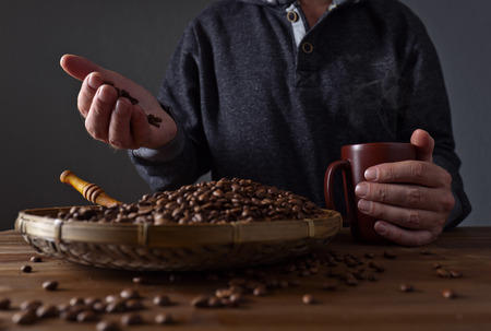 A man with a mug of hot coffeeの写真素材