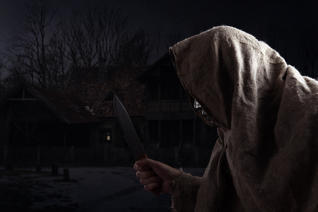 The hooded man with a big knifeの写真素材