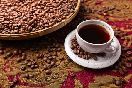Cup of black coffee and roasted beansの写真素材