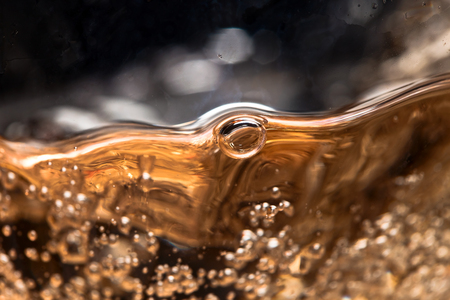 white wine in glass on black background, abstract splashing.の写真素材