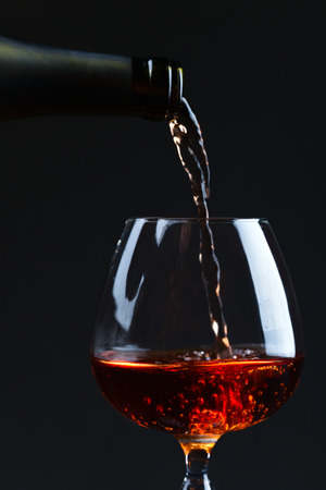 Snifter with brandy on a black backgroundの写真素材