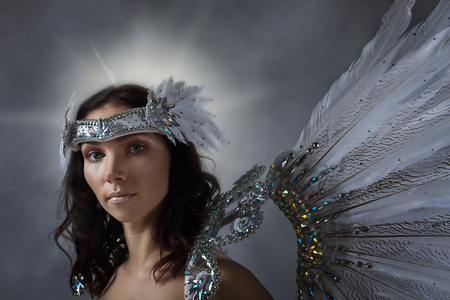 Young beautiful woman in white dress with angel wings の写真素材
