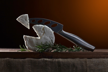 Fresh homemade goat cheese with rosemary and cheese knifeの写真素材