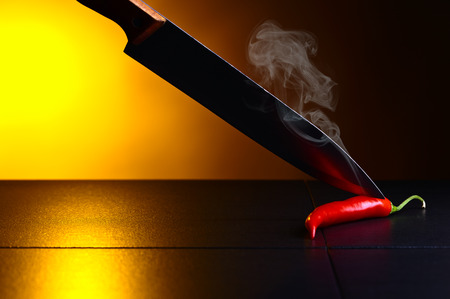 Hot red chilli pepper on black tableの写真素材