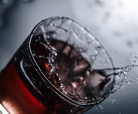 Whiskey with ice on a black backgroundの写真素材