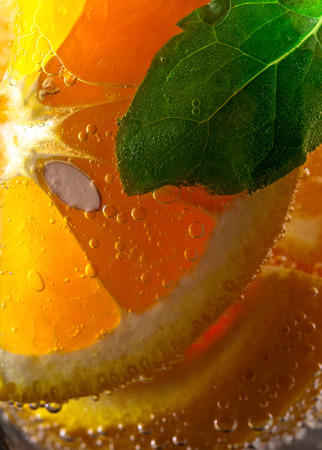 cold drink with orange and peppermint, macro shot , focus on centerの写真素材