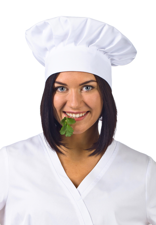 young woman in chef uniform with parsley isolated on white backgroundの写真素材