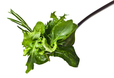 Fresh green salad with spinach,arugula and lettuce isolated on white backgroundの写真素材