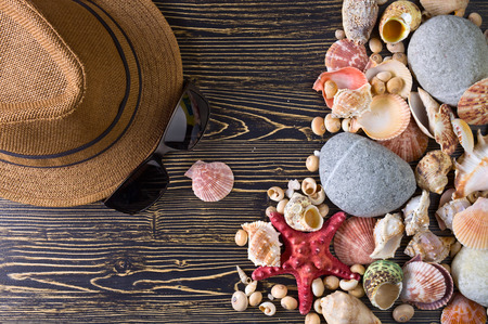 Beach accessories on wooden board .Concept of the summer time with starfish and sea shells on the...