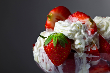 Strawberries and cream in glass bowl . Summer dessert .の写真素材