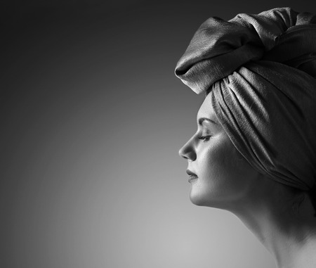 Profile of young woman in turban . Copy space for jour text.の写真素材