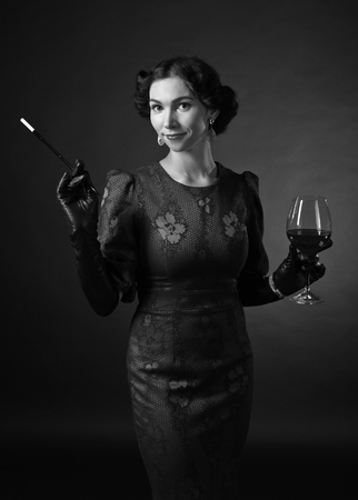 Beauty fashion model girl black and white portrait in retro style . Sexy woman portrait with perfect makeup and hair on black background.の写真素材